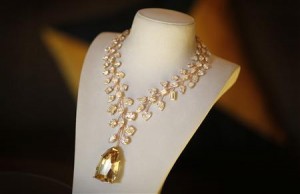 A rose gold necklace with a 407 carat yellow diamond.